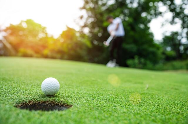 Golfer on the course at golden hour